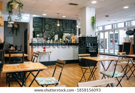 Empty modern cafe interior with chairs and tables Royalty-Free Stock Photo #1858156093