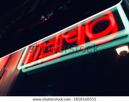 Reflected neon open sign at night