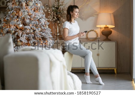 A brunette woman is engaged in online shopping in the website app on a laptop computer gadget. look away. the time before Christmas is shopping home for food products from a store near your home.