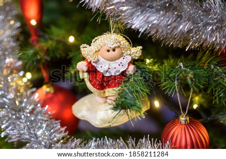 Christmas tree toy  in white-red dress on a Christmas tree in a Polish home, Christmas Eve, close-up, no people