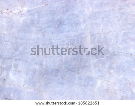 Surface of old white marble with cracks.