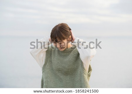 Portrait of a young woman taken in the evening with the sea in the background