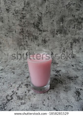 A bowl and a few glasses of delicious strawberry puding with wooden Background 