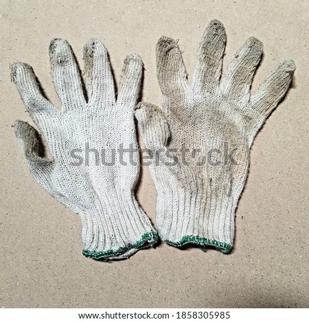 The dirty Glove left and right hand with background brown . two Glove with brown background 
