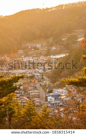 Aerial view of countryside village of Japan shine with sunset light in the evening, shot from Kawaguchiko, Yamanashi, Japan