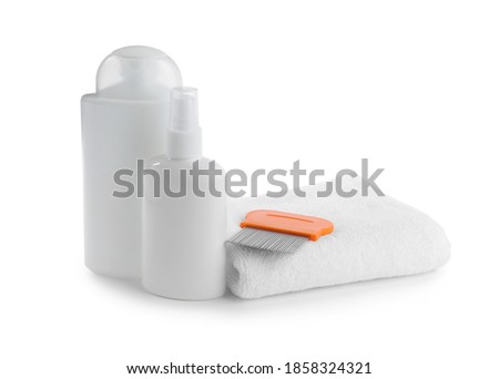 Products for anti lice treatment, metal comb and towel on white background