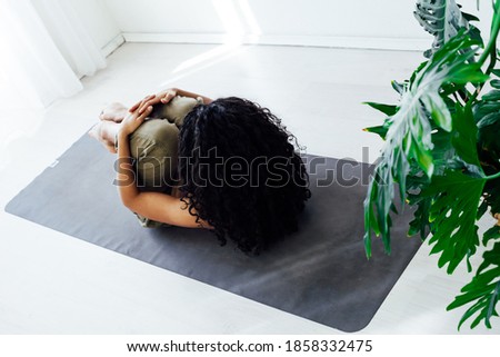 Female brunette engaged in yoga fitness asana body flexibility