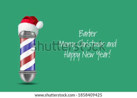 Barber Pole in Santa hat on a green background. Barber Merry Christmas and Happy New Year Concept. Beauty and fashion. Festive background.