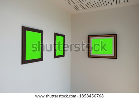 3 photo wooden frames mockup with green screen on off white colored perspective wall.