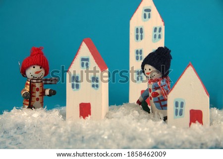 two snowman in the winter city. Horizontal image. Image contains copy space