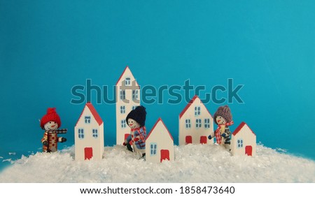 snowman in the winter city. Horizontal image. Image contains copy space