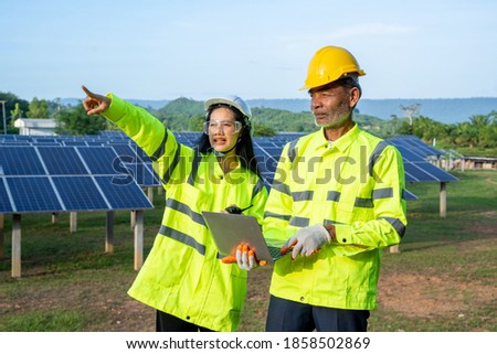 Engineer and Technician checking equipment in solar panels for great efficiency.