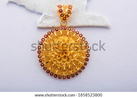 Golden smart look pendent with beautiful gems all around front view isolated on white background. Royalty-Free Stock Photo #1858523800