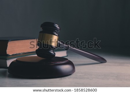 Wooden judge gavel and law books.