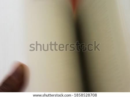 Concept speed read across book is quickly leafed through with the thumb blur due to movement