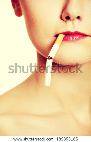 Front view face closeup holding a broken cigarette in lips