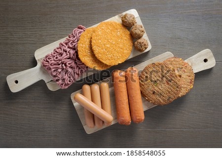 Flat lay of plant based vegetarian meat products for a plant based diet on a wooden table Royalty-Free Stock Photo #1858548055