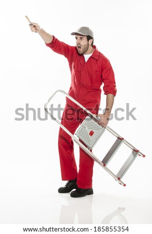 Full length portrait of an handyman in dungarees with a brush and a ladder