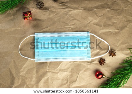 Antiviral mask as a gift for Christmas. Antiviral mask on Christmas background