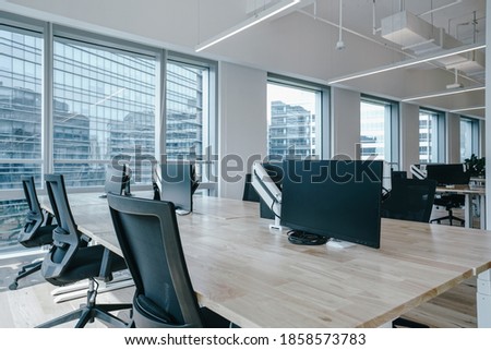 Interior of modern empty office building.Open white ceiling design with wooden floor.