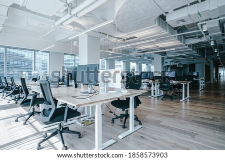 Interior of modern empty office building.Open white ceiling design with wooden floor. Royalty-Free Stock Photo #1858573903