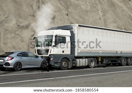 Frontal impact between a car and a truck. Car accident. Royalty-Free Stock Photo #1858580554