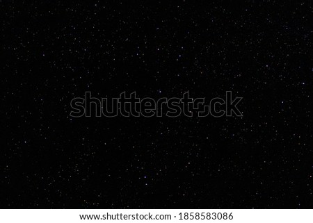 Starry night black sky fully with distant glowing stars. Real astro photo on summer night.