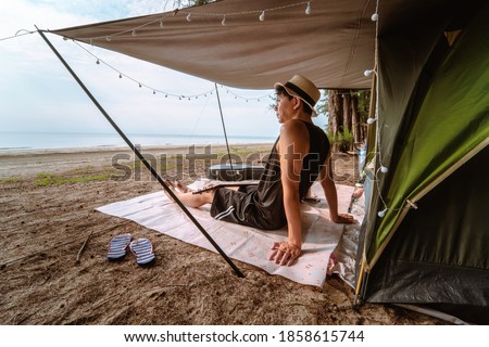 asian musician man playing guitar with happiness and joyful in summer vacation
