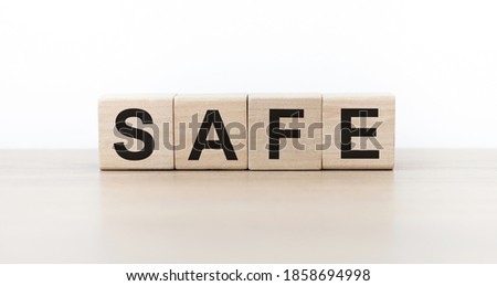 SAFE Word Written In Wooden Cubes On an isolated light table