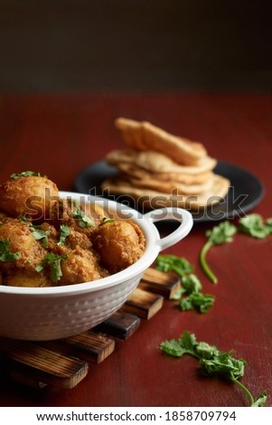 Food photography of fresh aloo dum with puri 