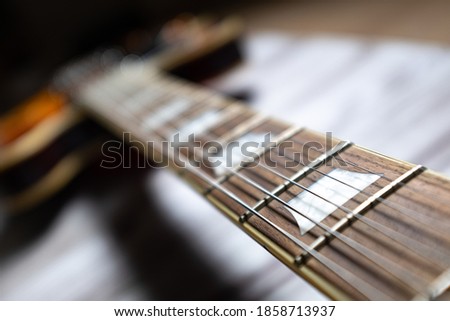 Rosewood neck six string guitar long perspective close up still