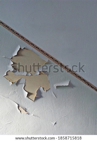 interior of the building old wall peeling paint, vertical photo