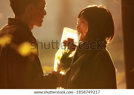 Men giving roses to women Royalty-Free Stock Photo #1858749217