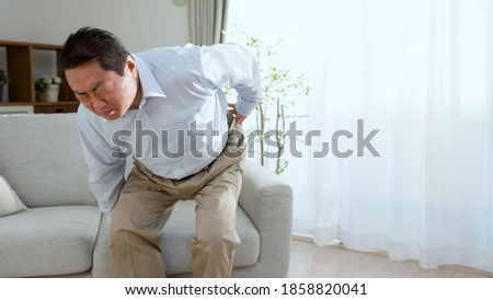 Middle-aged man rubbing his waist