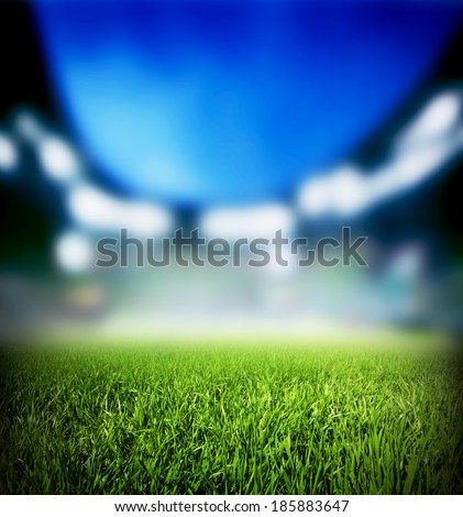 Football, soccer match. Grass close up. Night event lights on the stadium. Royalty-Free Stock Photo #185883647