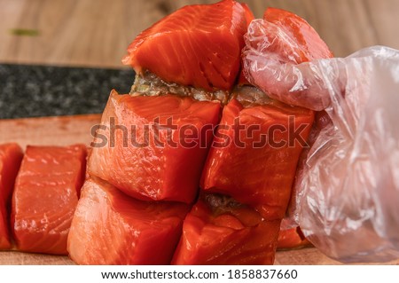 Pieces and strips of red fish, salmon fillets in different cooking methods. Salted and smoked trout