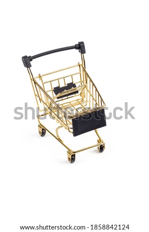 Studio lighting. children's shopping cart made of yellow metal with wheels. Close-up. On a white background, no isolation