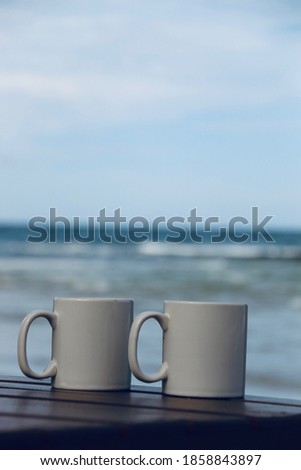 Coffee cup close-up picture with sea