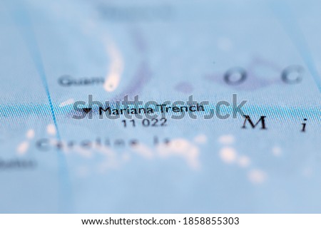 Shallow depth of field focus on geographical map location of Mariana Trench off coast of Philippines Pacific Ocean on atlas Royalty-Free Stock Photo #1858855303