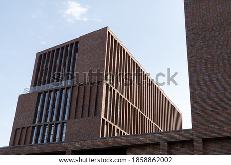 Facade of a red brick house with panoramic windows. Detailed pictures of exterior urban architecture. Minimal modern geometric architecture shape.Element of architecture. Geometric template.