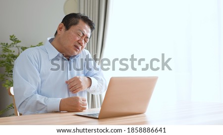 
Middle-aged man massaging his neck