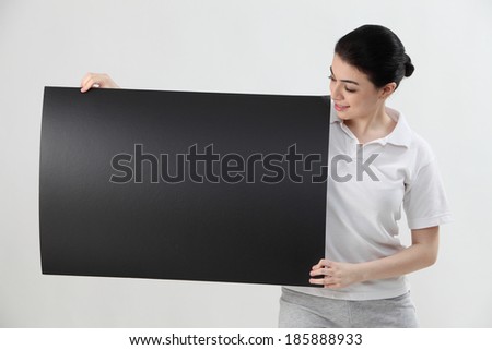 woman holding blank card and looking at card