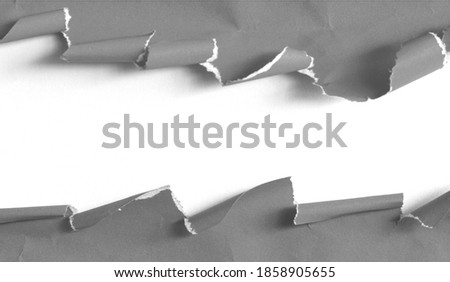 Ripped black paper on white background, space for advertising copy