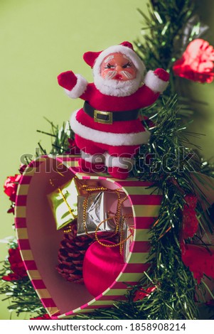 Christmas card include gift box with snowflake on christmas tree and Merry Christmas and Happy New Year. Green background 