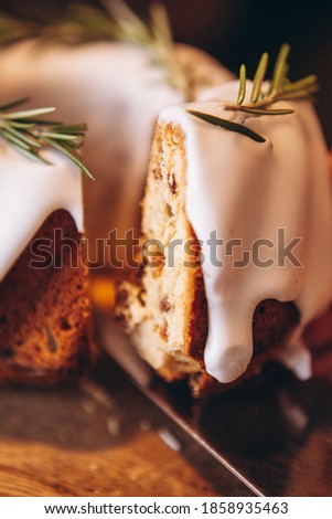 Christmas stollen: holiday pie decorated with rosemary and Christmas decor on the table. Сoncept for postcard, banner, holiday greeting