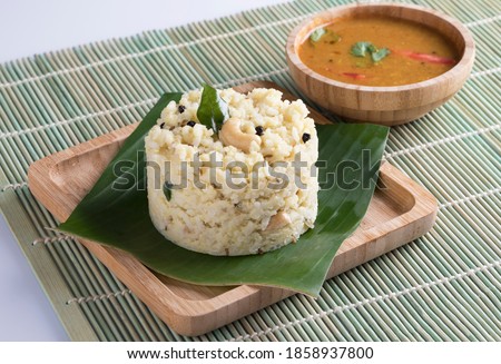 Ven Pongal with Sambar, coconut Chutney popular Indian breakfast food Tamil Nadu festival Pongal made with Rava or semolina in clay or wooden plate white background background side view, South India. Royalty-Free Stock Photo #1858937800