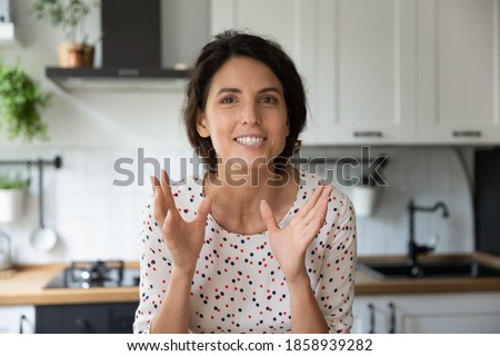 Close up portrait screen view of motivated young Caucasian woman talk speak on video call at home kitchen. Happy excited female teacher coach record webinar, have webcam conference or virtual meeting. Royalty-Free Stock Photo #1858939282