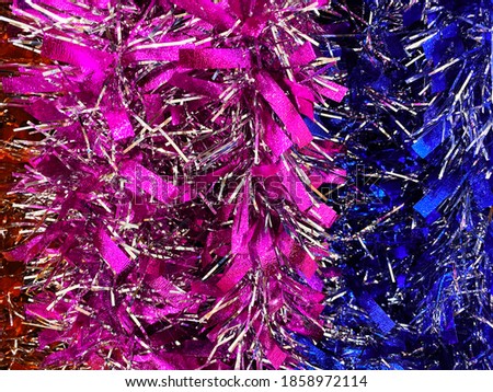 Colorful Christmas tinsel. New year's fluffy confetti. Sparkling ornament decoration concept . holiday background.