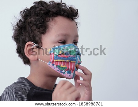 child wearing face masks protecting himself from coronavirus on white background stock photo