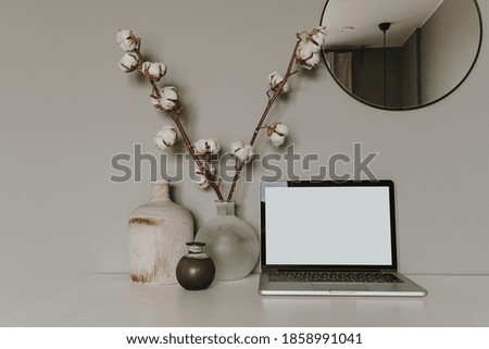 Blank screen laptop. Home office desk table workspace. Modern hygge interior design. Copy space mockup template. Front view freelancer, blogger work business concept.